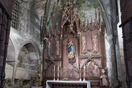 El retablo neogótico, obra de Maximino Magariños en 1906, presenta relieves en su base y alberga en el centro la imagen titular de la capilla, esculpida por Gregorio Fernández Prieto.